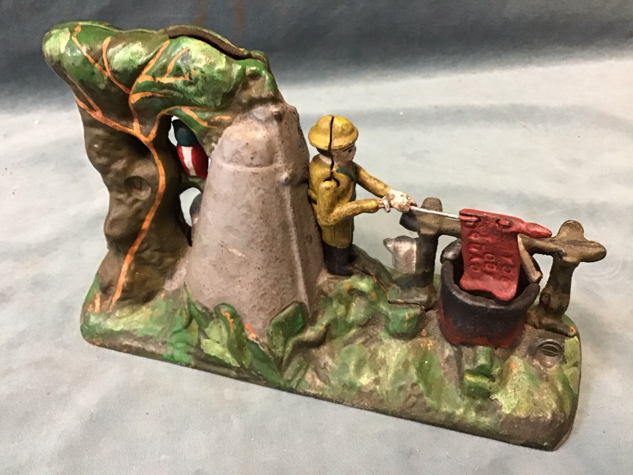 A painted cast iron mechanical boy scout camp moneybox cast with figures and foliage - 10in x 6in: - Image 2 of 3