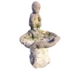 A composition stone garden birdbath cast as a shell with panpipe boy to rim, the square moulded