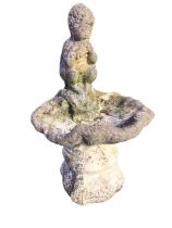 A composition stone garden birdbath cast as a shell with panpipe boy to rim, the square moulded