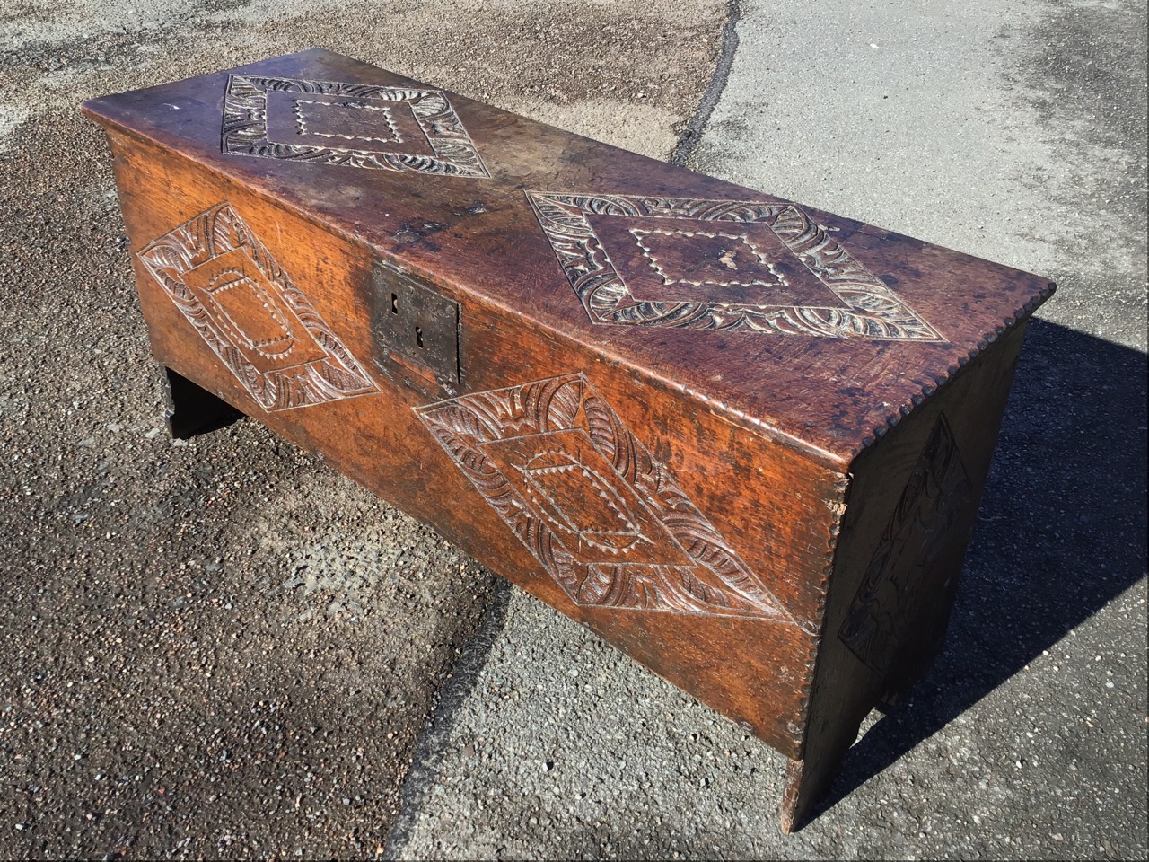 A C17th oak five plank coffer with later rectangular lozenge carved decoration, the interior with