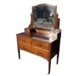 An Edwardian chequer strung mahogany dressing table, the arched bevelled mirror on shaped supports