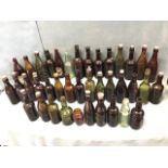 A collection of thirty-nine moulded brewery bottles mainly North Eastern, some with stoppers - Vaux,
