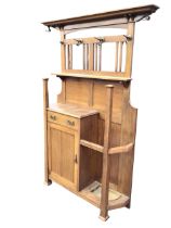 An Edwardian art nouveau oak hall stand in the style of Walter Cave with moulded cornice