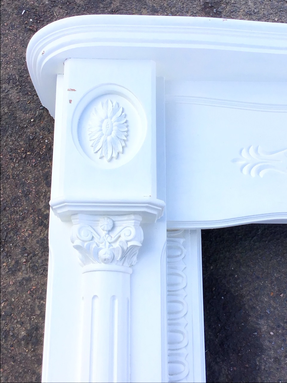 A Georgian style painted chimneypiece, the shaped mantelshelf above a carved frieze flanked by - Image 3 of 3