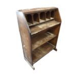 An oak bureau - lacking fallfront, having pigeoholes above open shelves. (30in)