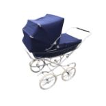 A Mothercare traditionally styled pram, the lined body with folding canvas hood, on a chromed