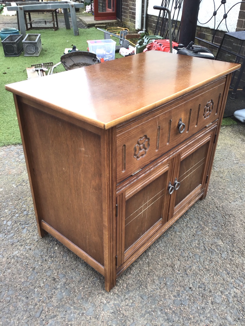 An oak cabinet with drop-down front compartment carved with fluting and flowerheads, above - Image 3 of 3