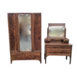 An Edwardian mahogany dressing table and wardrobe, the chest with bevelled mirror on tapering