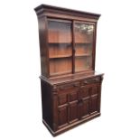 A Victorian stained bookcase cabinet with dentil cornice above a pair of sliding glass doors