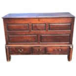 A C18th oak mule chest with rectangular top with fielded panelled front above three drawers
