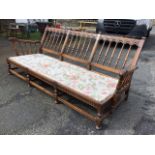 An Ercol elm Old Yorkshire pattern three-seater sofa with turned spindle back with carved