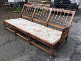 An Ercol elm Old Yorkshire pattern three-seater sofa with turned spindle back with carved