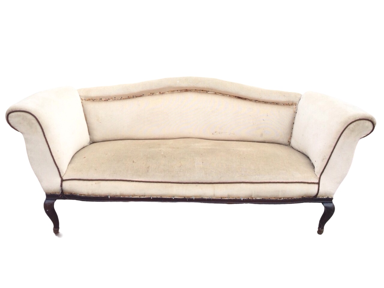 An Edwardian upholstered sofa with arched rolled back and rectangular sprung seat flanked by