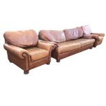 A leather three-piece suite with deep cushions and outscrolled arms with brass studding, the