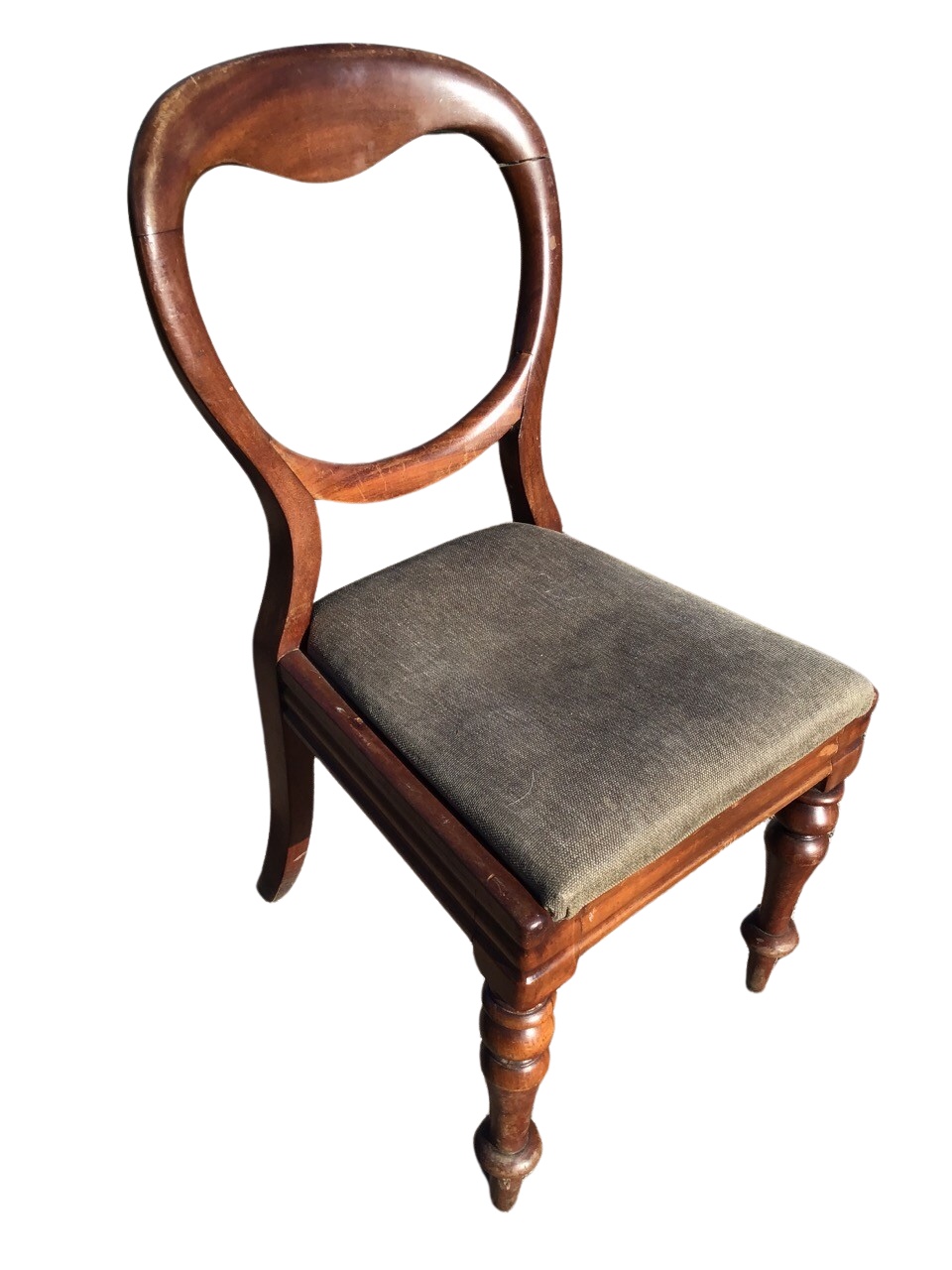 A Victorian mahogany balloon back chair with a drop-in upholstered seat on moulded rails, raised