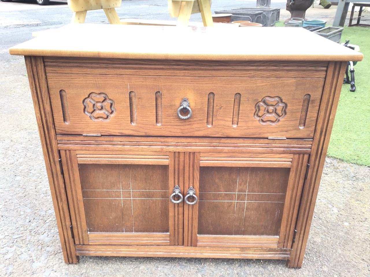 An oak cabinet with drop-down front compartment carved with fluting and flowerheads, above - Image 2 of 3