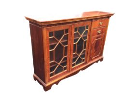 A Georgian style mahogany side cabinet with dentil cornice above a pair of astragal glazed doors and