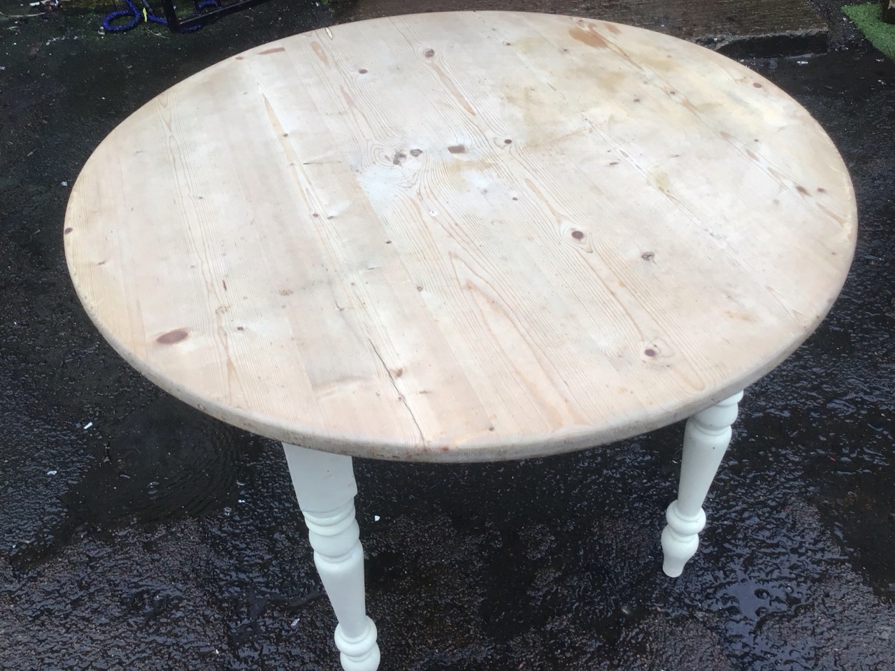 A pine kitchen table with circular top on a painted square base raised on turned tapering legs. ( - Image 2 of 3