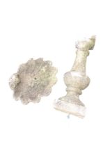 A composition stone birdbath with shell cast scalloped bowl on baluster column above square plinth -