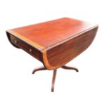 A regency mahogany pembroke table with rounded rectangular satinwood crossbanded top having two