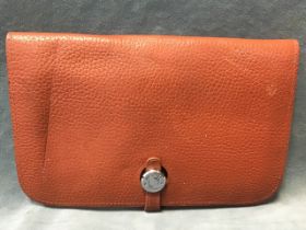 A Hermès brown leather wallet and removable purse, having twin pouches and card slots, with metal