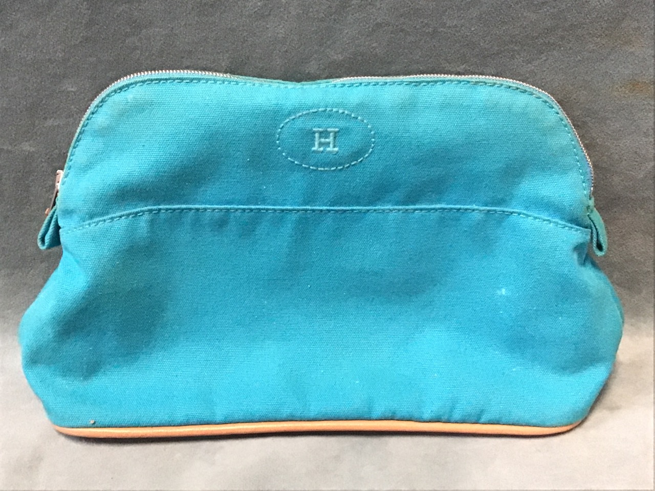 A lined Hermès blue cotton Bolide case with embroidered logo and leather piping.