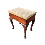 A rectangular oak stool with box seat having upholstered hinged lid, raised on cabriole legs with