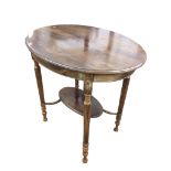 An Edwardian mahogany oval occasional table with moulded top raised on turned and reeded legs with