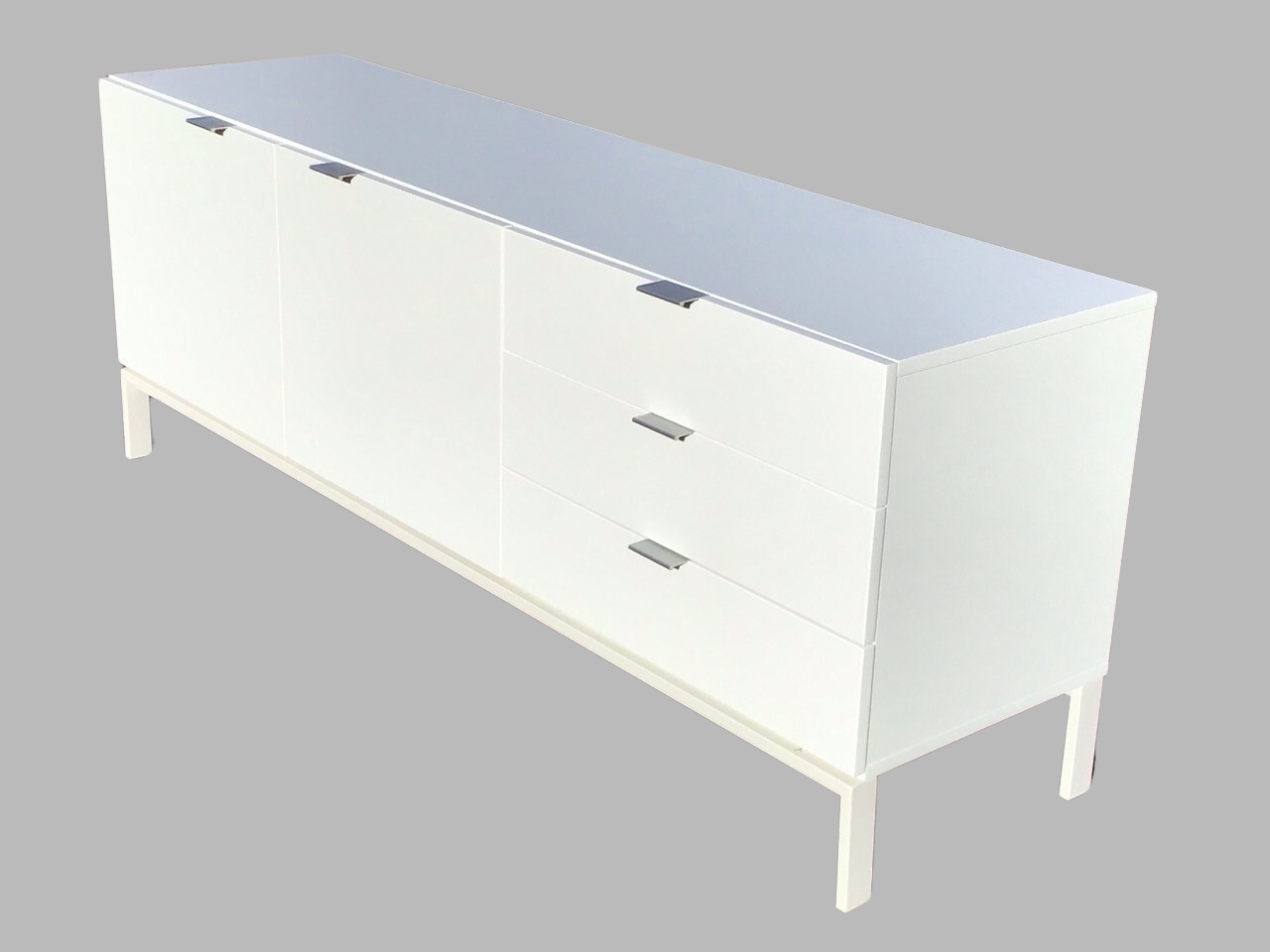 A contemporary white lacquered sideboard, the rectangular top above two cupboards and three drawers,