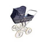 A Silver Cross pram, the detachable canvas body and folding hood with chromed fittings, on a tubular