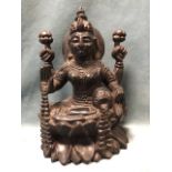 An Indian carved hardwood figure of the goddess Lakshmi, seated on a lotus flower. (10.25in)