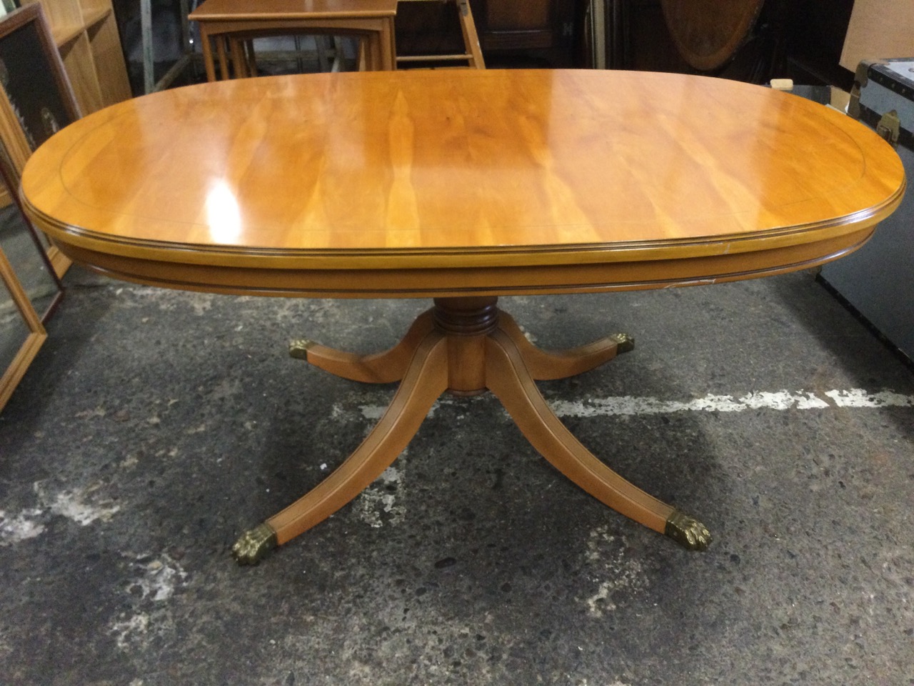 A regency style yew coffee table with moulded oval mahogany strung top on a turned column, raised on - Image 3 of 3