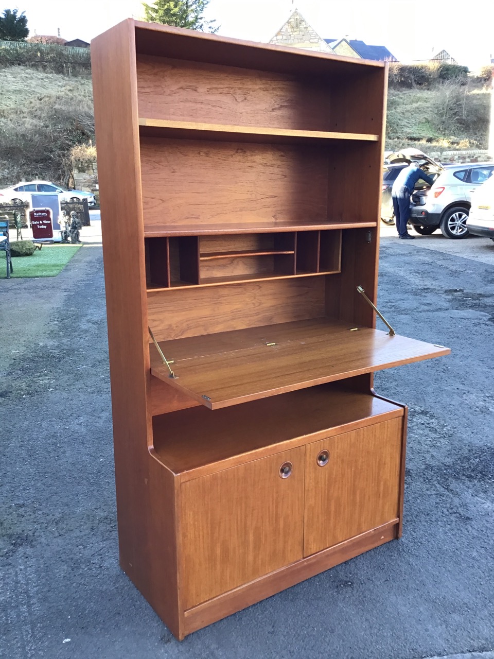 A 1970s teak bureau bookcase with rectangular open-shelf top above a fall-front desk with recessed - Image 2 of 3