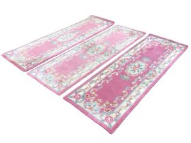 A set of three Chinese wool aubusson style rectangular runners with central floral medallions on