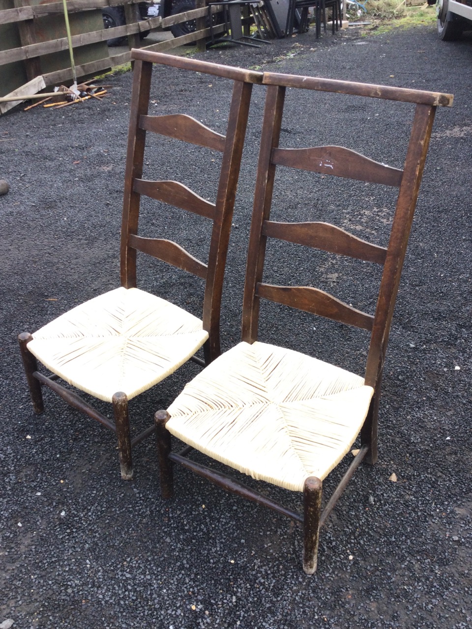 A pair of country ladderback chairs, the shaped flat top backs above arched rails and rush seats, - Bild 3 aus 3