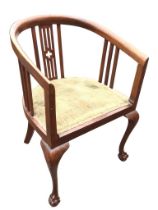 An Edwardian mahogany armchair with horseshoe shaped back and arms on pierced & slatted splats,
