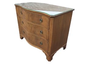A Georgian style mahogany serpentine fronted chest of drawers with plate glass to top above three