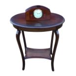 An Edwardian mahogany occasional table with oval moulded top above a plain apron, raised on square