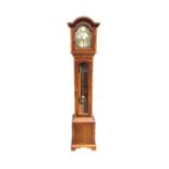 A Georgian style yew longcase clock by Thomas Byrne with arched cornice and brass dial with silvered