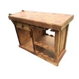 A rustic pine kitchen cart with rectangular tiled top and rail to the side above a moulded drawer,