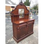 A Victorian mahogany chiffonier with arched scroll carved back having central mirror flanked by