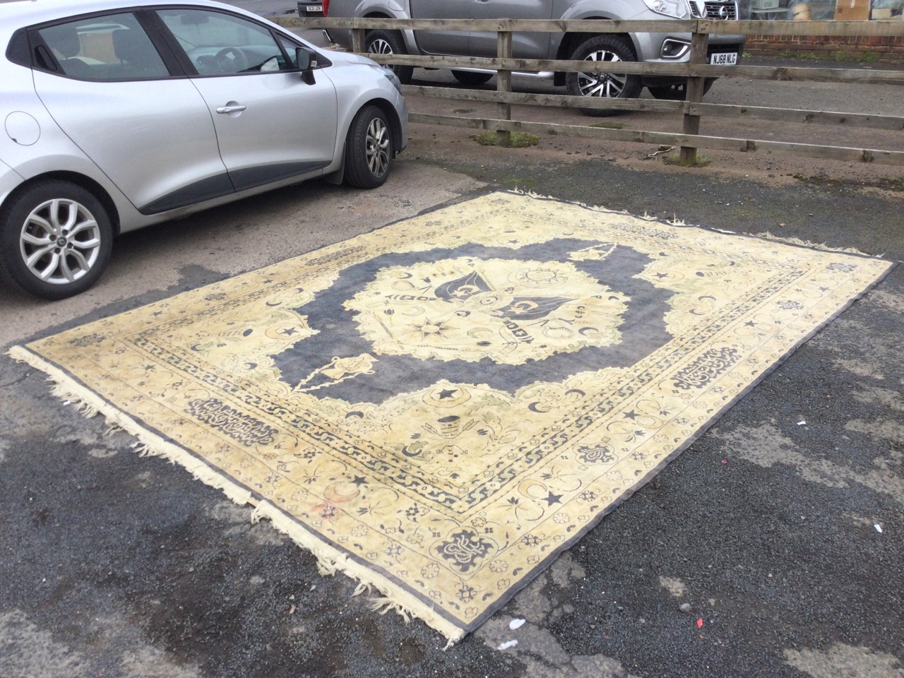 A Turkish wool carpet woven with central medallion of national flags & symbols and military