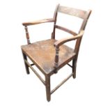 A nineteenth century elm & oak country elbow chair with bar back and shaped arms supported on turned