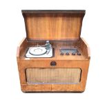 A 50s walnut cased Ferguson radiogram, the sloped lid to cabinet enclosing turntable, radio dial &