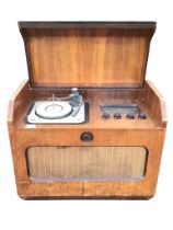 A 50s walnut cased Ferguson radiogram, the sloped lid to cabinet enclosing turntable, radio dial &