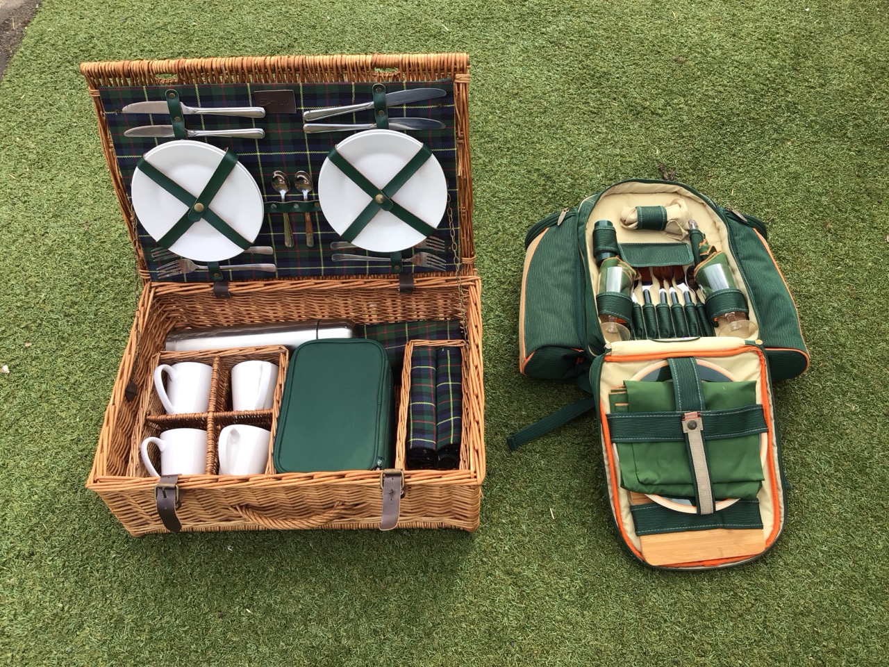 An Optima wicker picnic hamper with leather mounts - four settings with plates, mugs, cutlery,