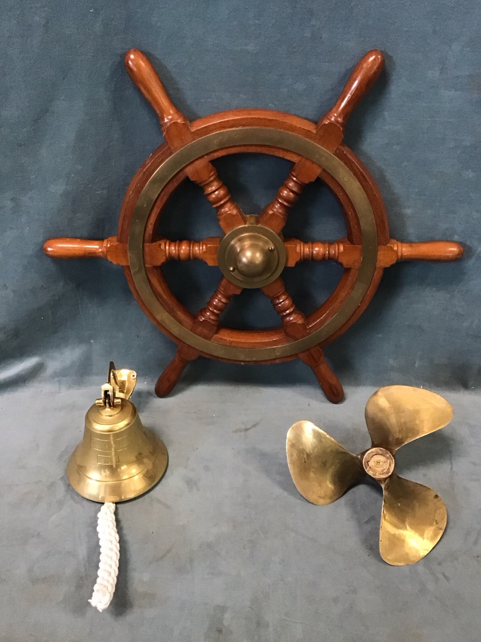 A teak & brass ships wheel with turned spokes & six handles with brass mounts; a reproduction