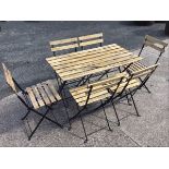 A folding garden table & chair set of slatted construction on rectangular folding legs with pad feet