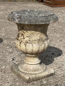 A Victorian carved marble campana shaped garden urn with flared rim above a gadrooned body on a