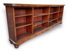 A late Victorian rosewood open bookcase with rounded shaped top above four banks of adjustable